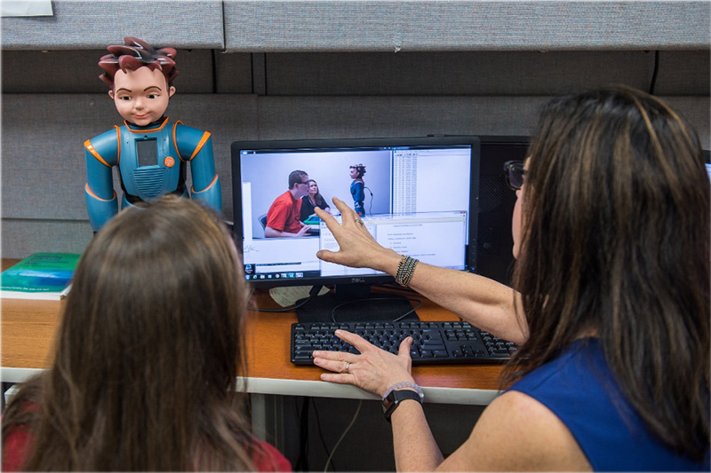 Researchers evaluate data in the Robots for Autism research project.